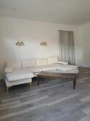 a living room with a white couch and a coffee table at Labelle in Wilkes-Barre