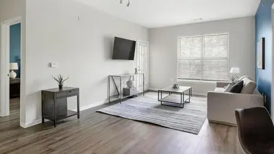 a living room with a couch and a table at Landing Spectacular 2BD Clubhouse Pool in King of Prussia