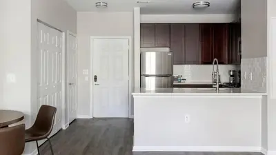 a white kitchen with a counter and a refrigerator at Landing Spectacular 2BD Clubhouse Pool in King of Prussia