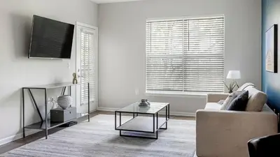 a living room with a couch and a table at Landing Spectacular 2BD Clubhouse Pool in King of Prussia