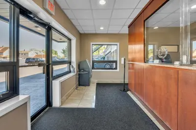an office with a hallway with a bar and windows at Bentley Motel in Linden