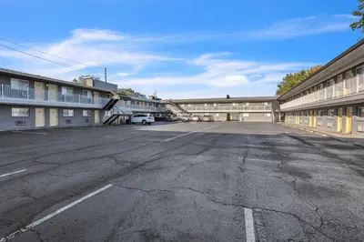 an empty parking lot in front of a building at Bentley Motel in Linden