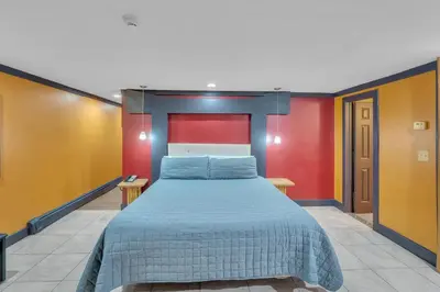 a bed in a room with red and yellow walls at Bentley Motel in Linden