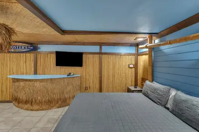 a room with a bed and a flat screen tv at Bentley Motel in Linden