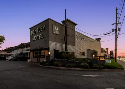 a building with a sign that reads berkeley motel at Bentley Motel in Linden