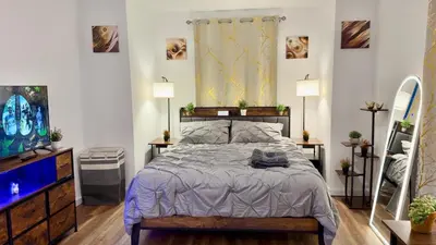 a bedroom with a bed and two lamps and a tv at Spacious Private Ensuite, With Private Bath, Outdoor Space, Workstation, Gym, & All Utilities Included in Point Breeze Home in Philadelphia