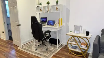 a desk with a chair and a computer in a room at Spacious Private Ensuite, With Private Bath, Outdoor Space, Workstation, Gym, & All Utilities Included in Point Breeze Home in Philadelphia