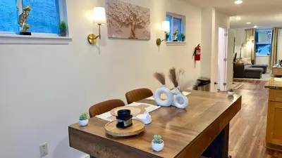 a dining room with a table and chairs at Spacious Private Ensuite, With Private Bath, Outdoor Space, Workstation, Gym, & All Utilities Included in Point Breeze Home in Philadelphia