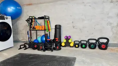a group of exercise equipment on a floor next to a wall at Spacious Private Ensuite, With Private Bath, Outdoor Space, Workstation, Gym, & All Utilities Included in Point Breeze Home in Philadelphia