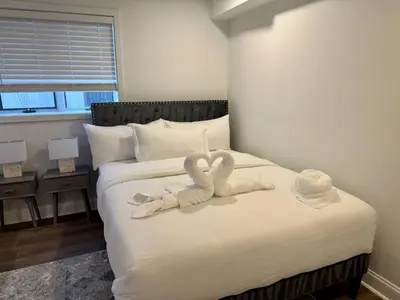 two towels in the shape of swans on a bed at Top Luxe Oasis -Ski, Hike, Firepit, Spa, Golf in Vernon Township