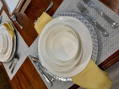 two white plates sitting on a table with silverware at Top Luxe Oasis -Ski, Hike, Firepit, Spa, Golf in Vernon Township