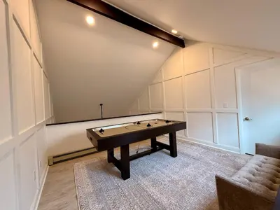a ping pong table in the middle of a room at Top Luxe Oasis -Ski, Hike, Firepit, Spa, Golf in Vernon Township