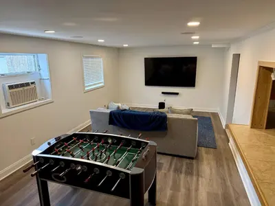 a living room with a couch and a foos ball at Top Luxe Oasis -Ski, Hike, Firepit, Spa, Golf in Vernon Township