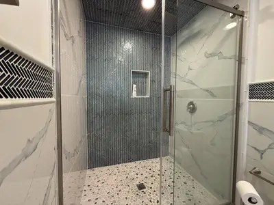 a shower with a glass door in a bathroom at Top Luxe Oasis -Ski, Hike, Firepit, Spa, Golf in Vernon Township