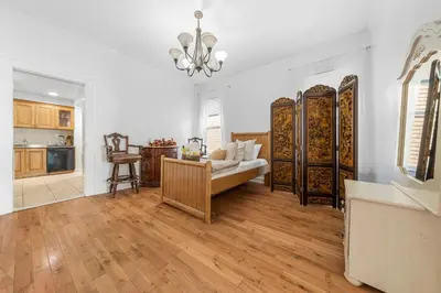 a living room with a couch and a kitchen at Quiet Retreat 10 Min to NYC Train & free Parking in Bayonne