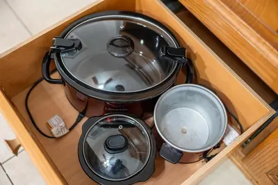 a pot sitting on top of a stove in a drawer at Quiet Retreat 10 Min to NYC Train & free Parking in Bayonne