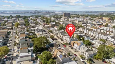 an aerial view of a city with a red street sign at Quiet Retreat 10 Min to NYC Train & free Parking in Bayonne