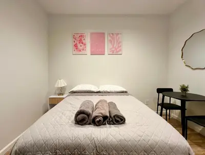a bedroom with a bed with towels on it at The Marquee House in New York