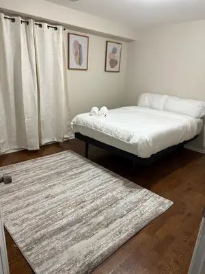 a bedroom with two beds and a rug at Charming Large 3 beds-2 bath Newark EWR NYC in Newark