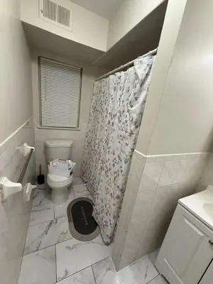 a bathroom with a toilet and a shower curtain at Charming Large 3 beds-2 bath Newark EWR NYC in Newark