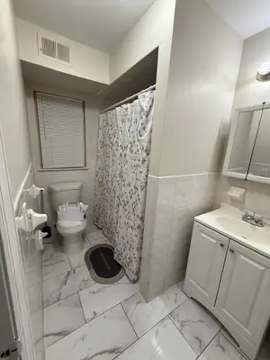 a bathroom with a toilet and a shower and a sink at Charming Large 3 beds-2 bath Newark EWR NYC in Newark
