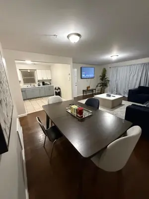 a living room with a table and chairs and a couch at Charming Large 3 beds-2 bath Newark EWR NYC in Newark