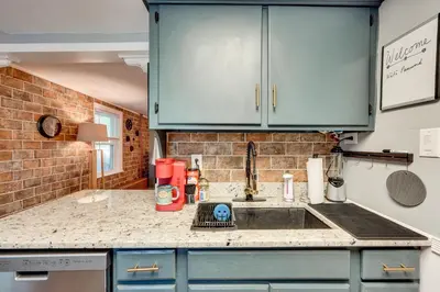 a kitchen with blue cabinets and a sink at Little Woodland Home Hidden Gem By Dtwn Bethlehem in Bethlehem