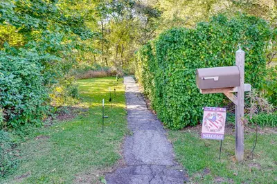a garden with a mailbox next to a hedge at Little Woodland Home Hidden Gem By Dtwn Bethlehem in Bethlehem