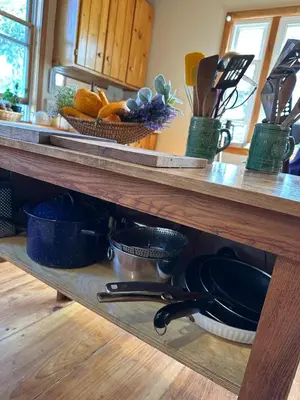 a kitchen counter with pots and pans on a shelf at Rutland Hill Farmhouse in Mansfield