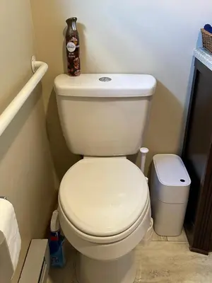 a bathroom with a toilet with a bottle on top of it at Rutland Hill Farmhouse in Mansfield