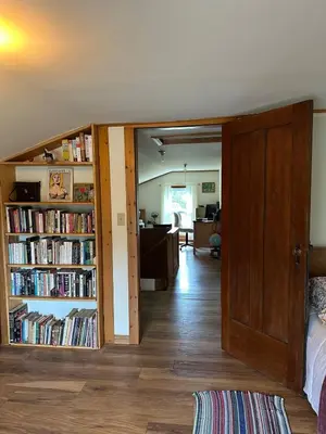a bedroom with a book shelf filled with books at Rutland Hill Farmhouse in Mansfield