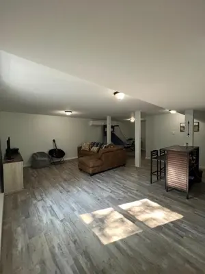 a living room with a couch and a table at Chalet Montelago in The Hideout in Lake Ariel