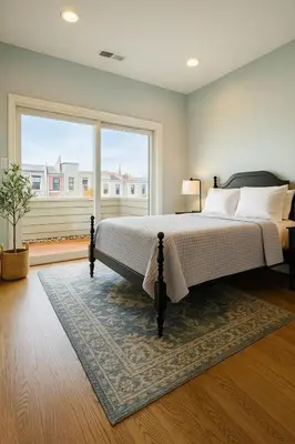 a bedroom with a bed and a large window at Modern Riverfront Rowhome, Walk to Fishtown in Philadelphia