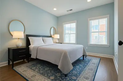 a bedroom with a bed with two lamps and a rug at Modern Riverfront Rowhome, Walk to Fishtown in Philadelphia