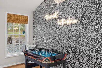 a ping pong table in a room with a patterned wall at Pocono Lake Escape, includes Golf Cart, Firepit in Pocono Lake