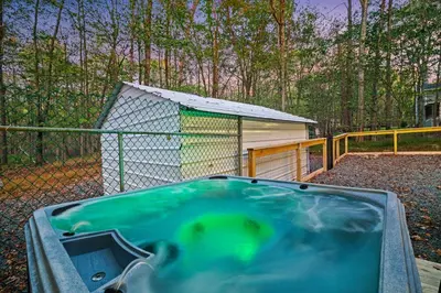 a hot tub in a yard next to a shed at Pocono Lake Escape, includes Golf Cart, Firepit in Pocono Lake