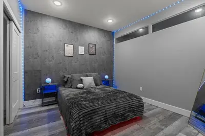 a bedroom with a bed and two blue tables at Lunar Escape 1 Bd Near Zoo, Rocky Steps & Downtown in Philadelphia