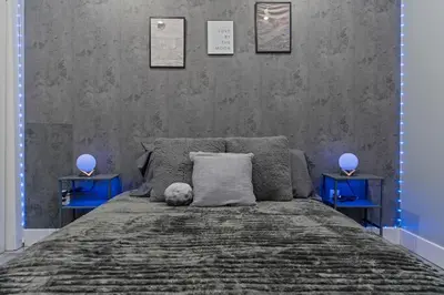 a bedroom with a bed with a teddy bear on it at Lunar Escape 1 Bd Near Zoo, Rocky Steps & Downtown in Philadelphia