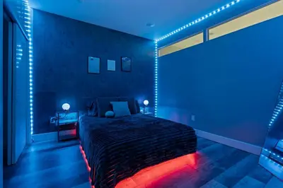 a bedroom with a bed with blue lights on it at Lunar Escape 1 Bd Near Zoo, Rocky Steps & Downtown in Philadelphia