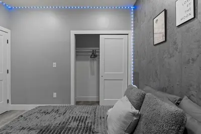 a living room with a couch and a white door at Lunar Escape 1 Bd Near Zoo, Rocky Steps & Downtown in Philadelphia