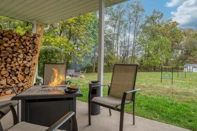 a patio with a table and chairs and a fire pit at Family Escape with Yard, Fire Pit and EV Charger in Palmyra