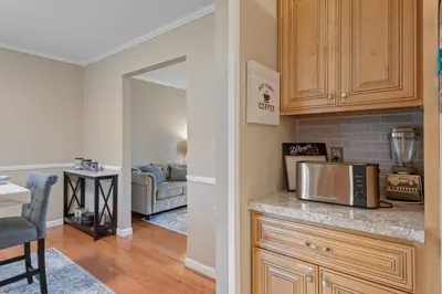 a kitchen with a microwave and a living room at Family Escape with Yard, Fire Pit and EV Charger in Palmyra