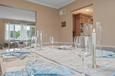 a dining room table with wine glasses on it at Family Escape with Yard, Fire Pit and EV Charger in Palmyra