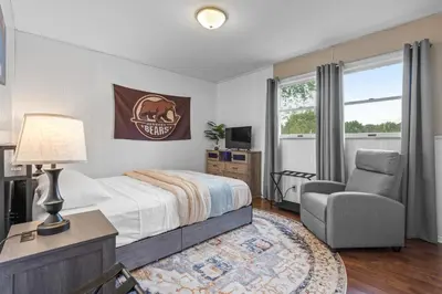 a bedroom with a bed and a chair at Family Escape with Yard, Fire Pit and EV Charger in Palmyra