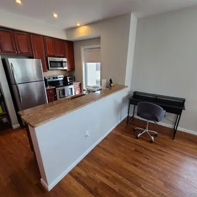 a kitchen with a counter and a desk in it at Spacious Apt in Fairview NJ Easy Commute to NYC with parking in Fairview