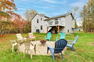 a group of chairs sitting in a yard in front of a house at Less Than 1 Mi to Lake Family Home in Albrightsville! in Albrightsville