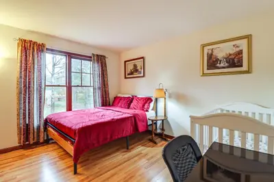 a bedroom with a bed with red sheets and a window at Less Than 1 Mi to Lake Family Home in Albrightsville! in Albrightsville