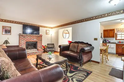 a living room with leather furniture and a fireplace at Less Than 1 Mi to Lake Family Home in Albrightsville! in Albrightsville