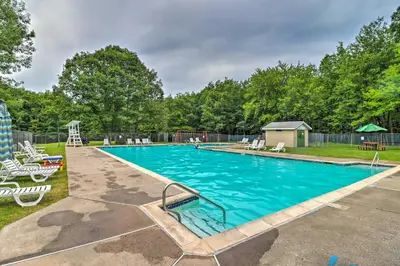 an empty swimming pool with chairs in a yard at Less Than 1 Mi to Lake Family Home in Albrightsville! in Albrightsville