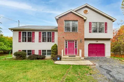 a house with a red door at Less Than 1 Mi to Lake Family Home in Albrightsville! in Albrightsville